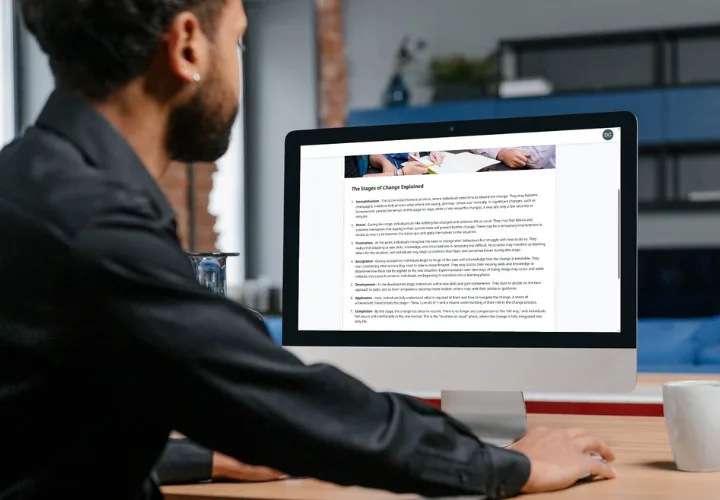 man using computer reading about managing change