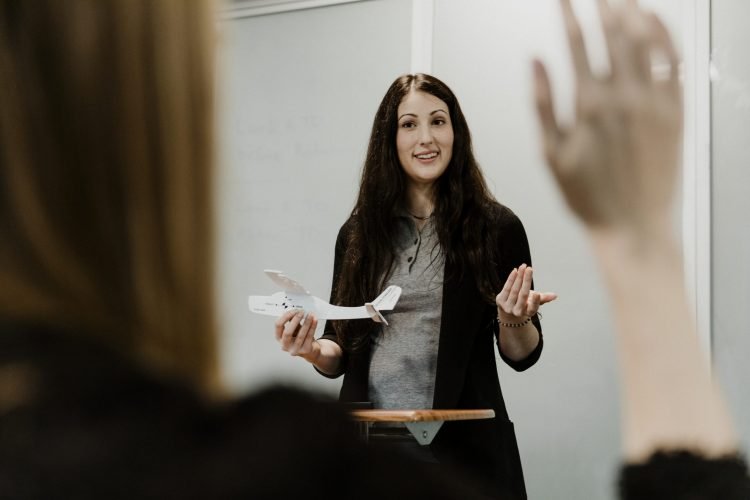 Woman explaining aerodynamics in a classroom Woman explaining aerodynamics in a classroom