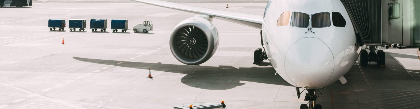Aircraft Plane Boarding Passengers In Airport Terminal. Aircraft Aircraft Plane Boarding Passengers In Airport Terminal. Aircraft Tow Tractor And Fright Forklift Near Plane.
